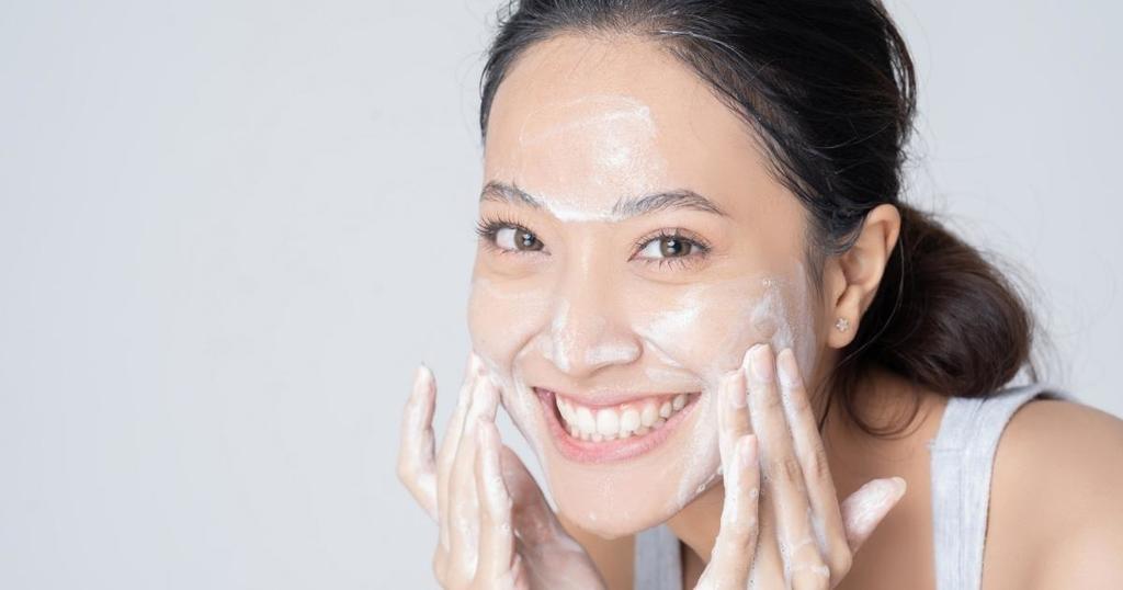 woman washing face with milk the bailiwick academy