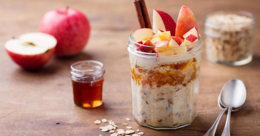 overnight oats in a glass topped with apples the bailiwick academy